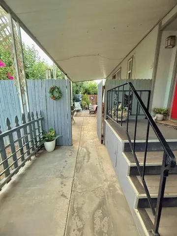 a view of an chairs and bench in balcony
