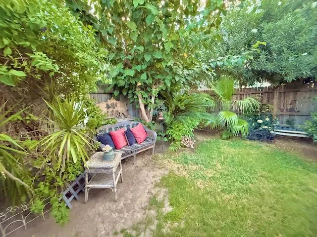 a wooden bench sitting in the middle of a garden