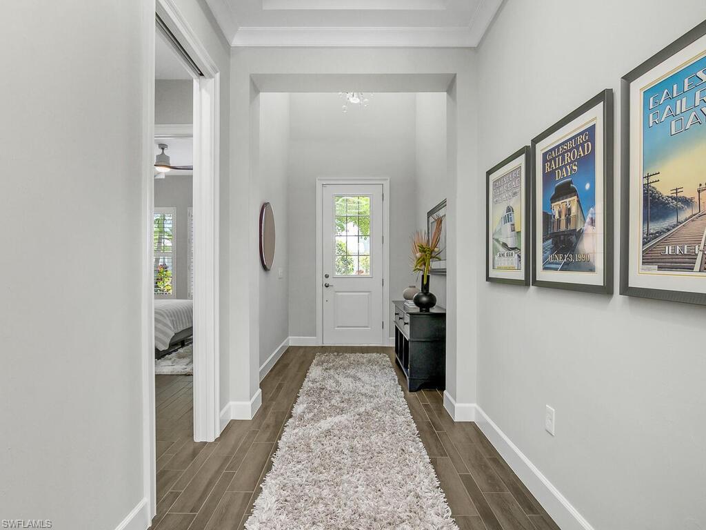 6478 Warwick Avenue Naples, FL 34113 - Photo 13 of 47 a view of a hallway view with wooden floor and living space