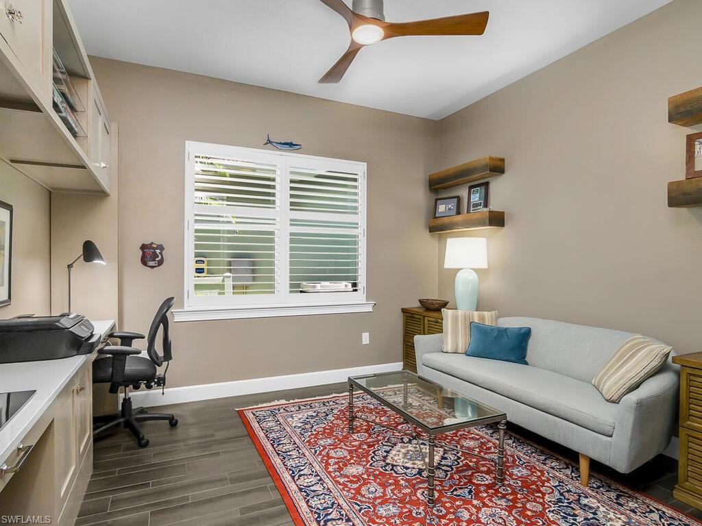 6478 Warwick Avenue Naples, FL 34113 - Photo 15 of 47 a living room with furniture and a rug