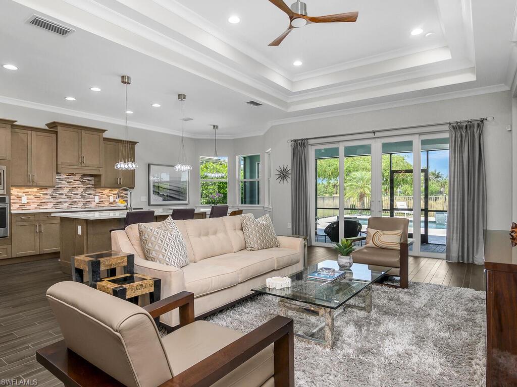 6478 Warwick Avenue Naples, FL 34113 - Photo 19 of 47 a living room with furniture and a large window