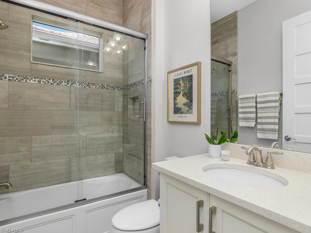 6478 Warwick Avenue Naples, FL 34113 - Photo 33 of 47 a bathroom with a sink and a mirror