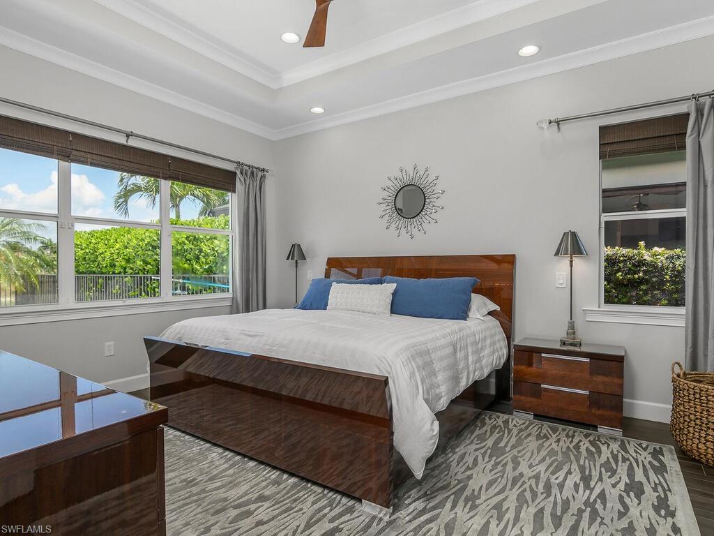 6478 Warwick Avenue Naples, FL 34113 - Photo 9 of 47 a bedroom with a large bed and a window