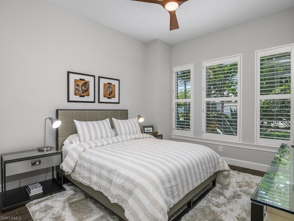 6478 Warwick Avenue Naples, FL 34113 - Photo 10 of 47 a bedroom with a bed and a large window