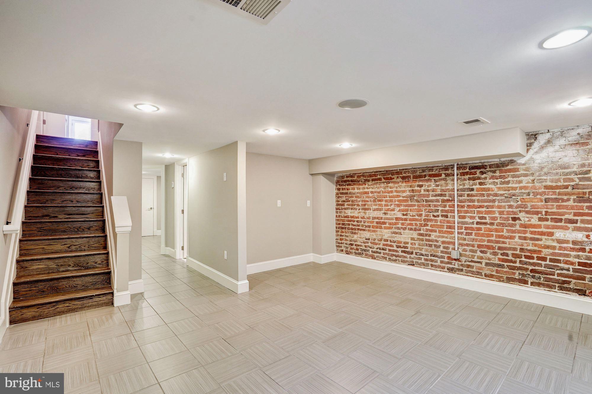 1333 East Capitol Street Southeast Washington, DC 20003 - Photo 28 of 43 Finished lower level w/exposed brick & front entry