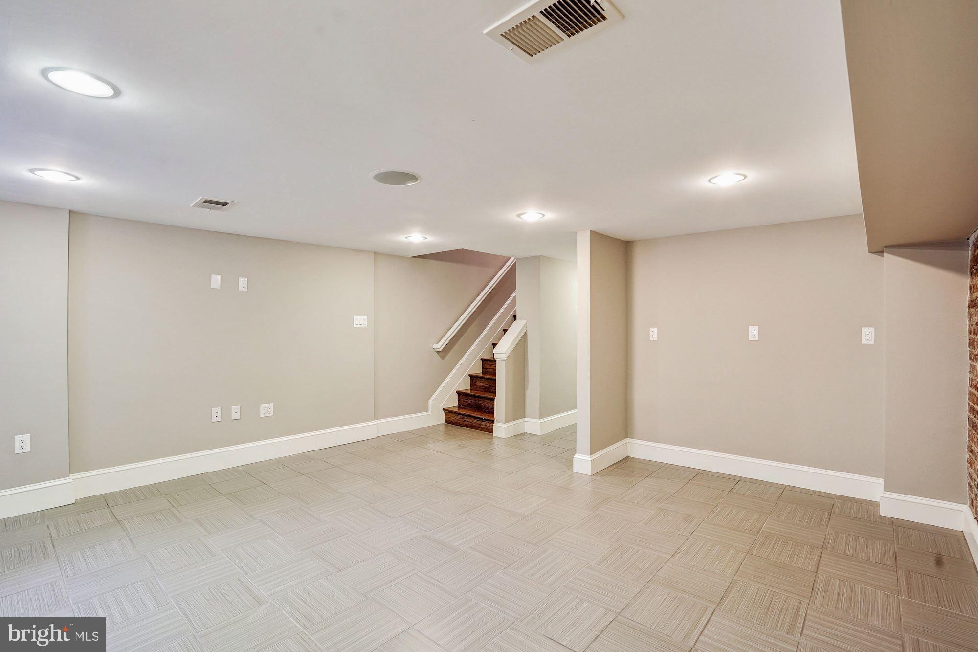 1333 East Capitol Street Southeast Washington, DC 20003 - Photo 30 of 43 Finished lower level w/exposed brick & front entry