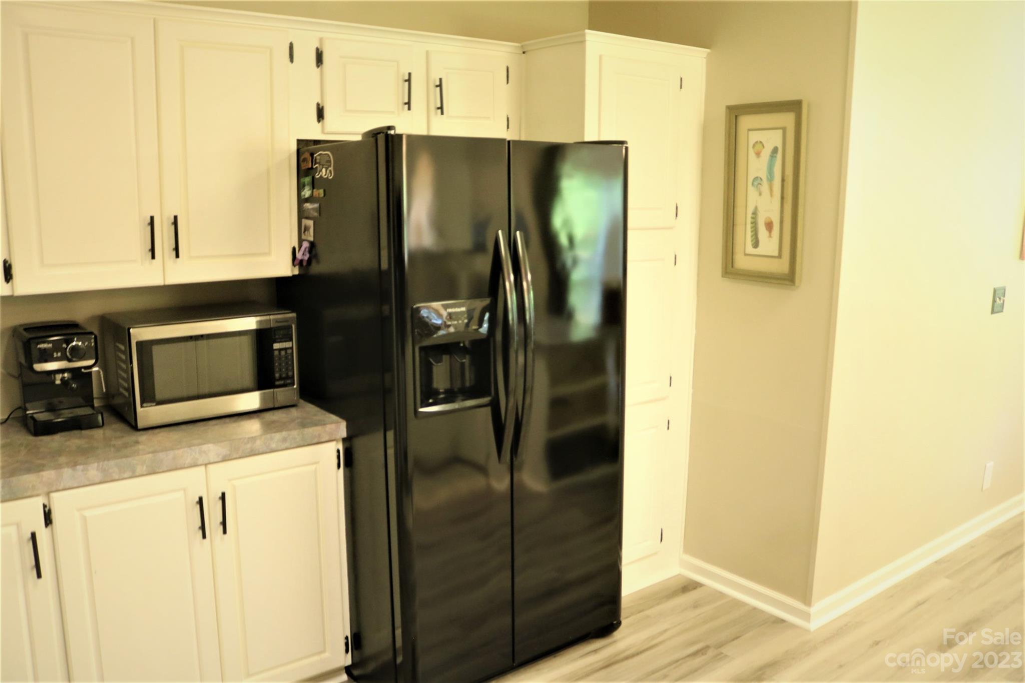 2919 Grassy Knob Road Mill Spring, NC 28756 - Photo 11 of 29 a kitchen with a refrigerator and cabinets
