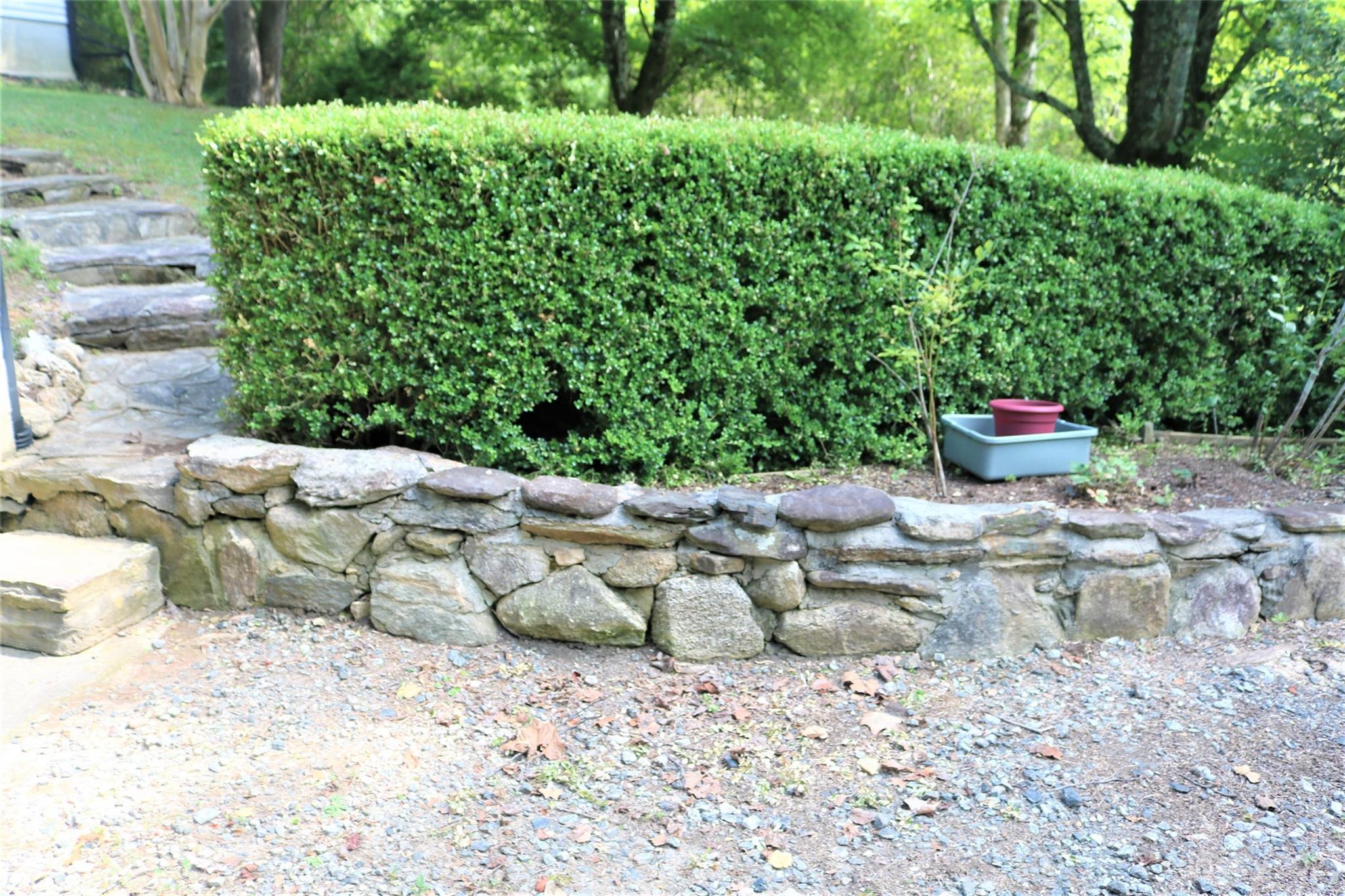 2919 Grassy Knob Road Mill Spring, NC 28756 - Photo 18 of 29 a view of a backyard with table and chairs potted plants
