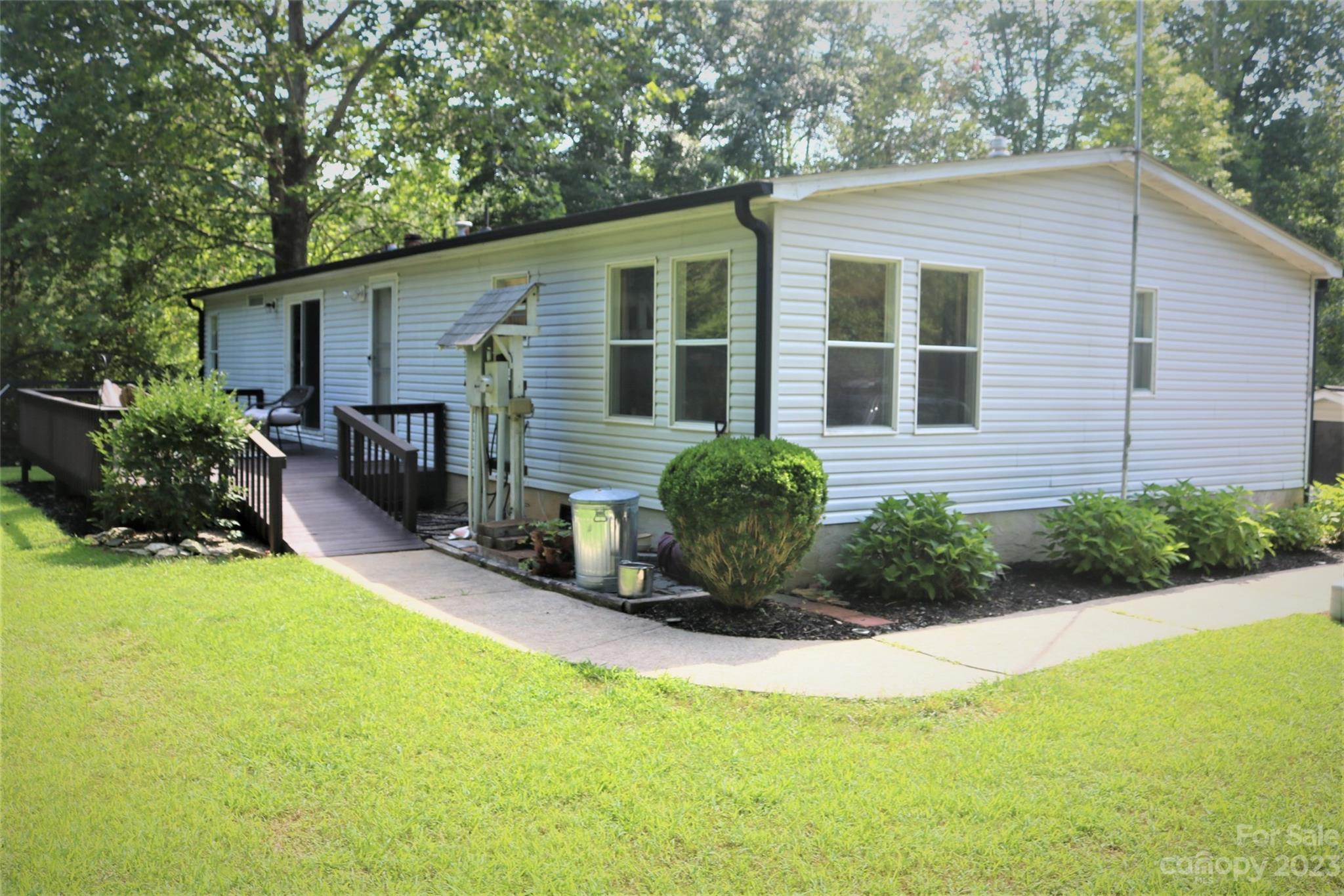 2919 Grassy Knob Road Mill Spring, NC 28756 - Photo 19 of 29 a front view of a house with yard and outdoor seating