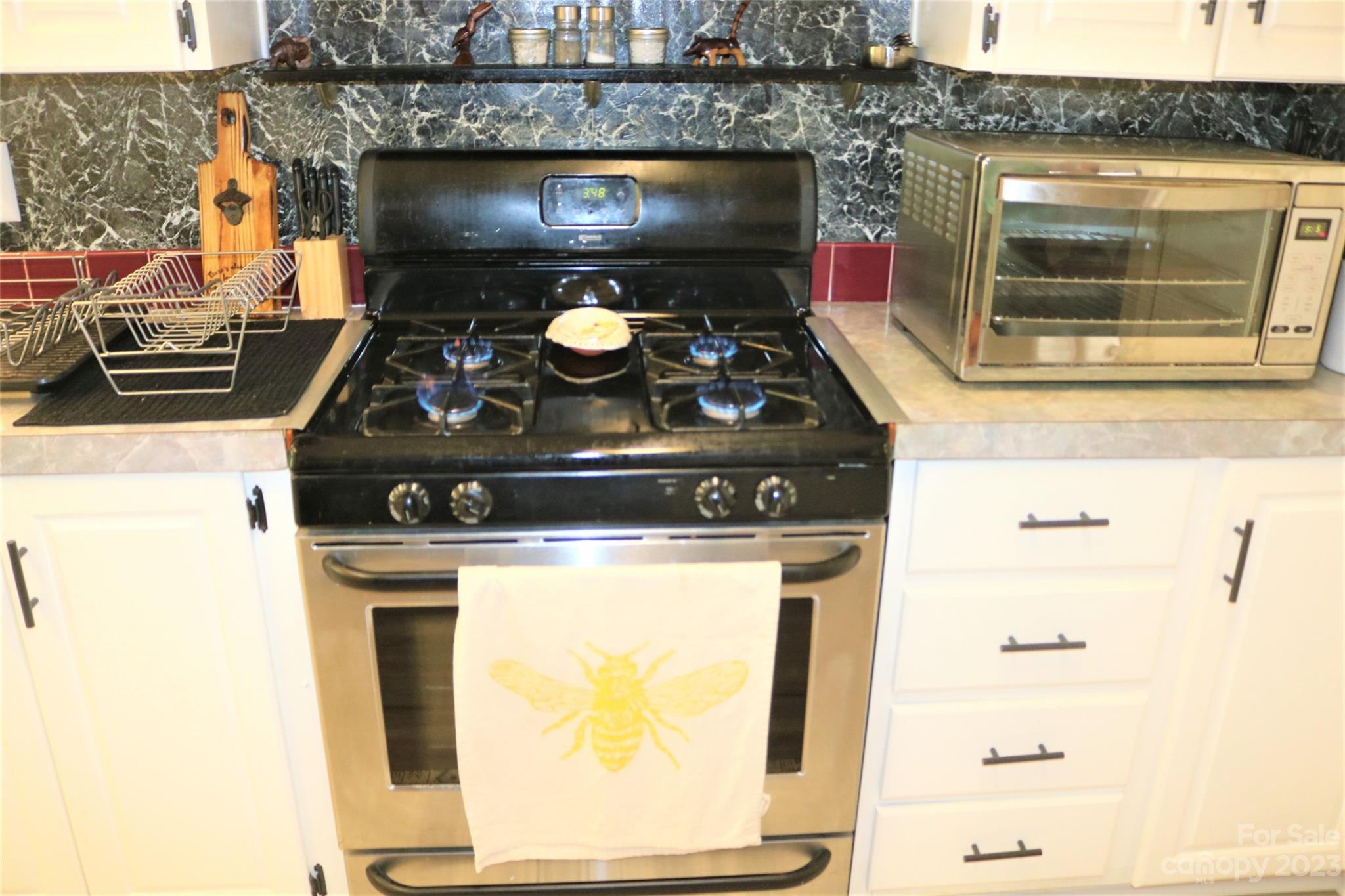 2919 Grassy Knob Road Mill Spring, NC 28756 - Photo 9 of 29 a stove top oven sitting inside of a kitchen