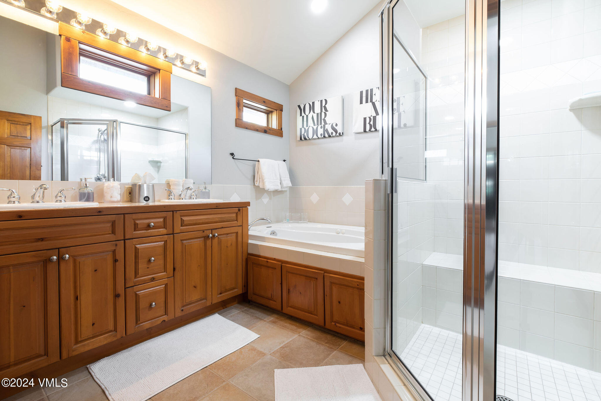 76 Knudson Ranch Road Edwards, CO 81632 - Photo 15 of 25 a bathroom with a tub a sink and a mirror