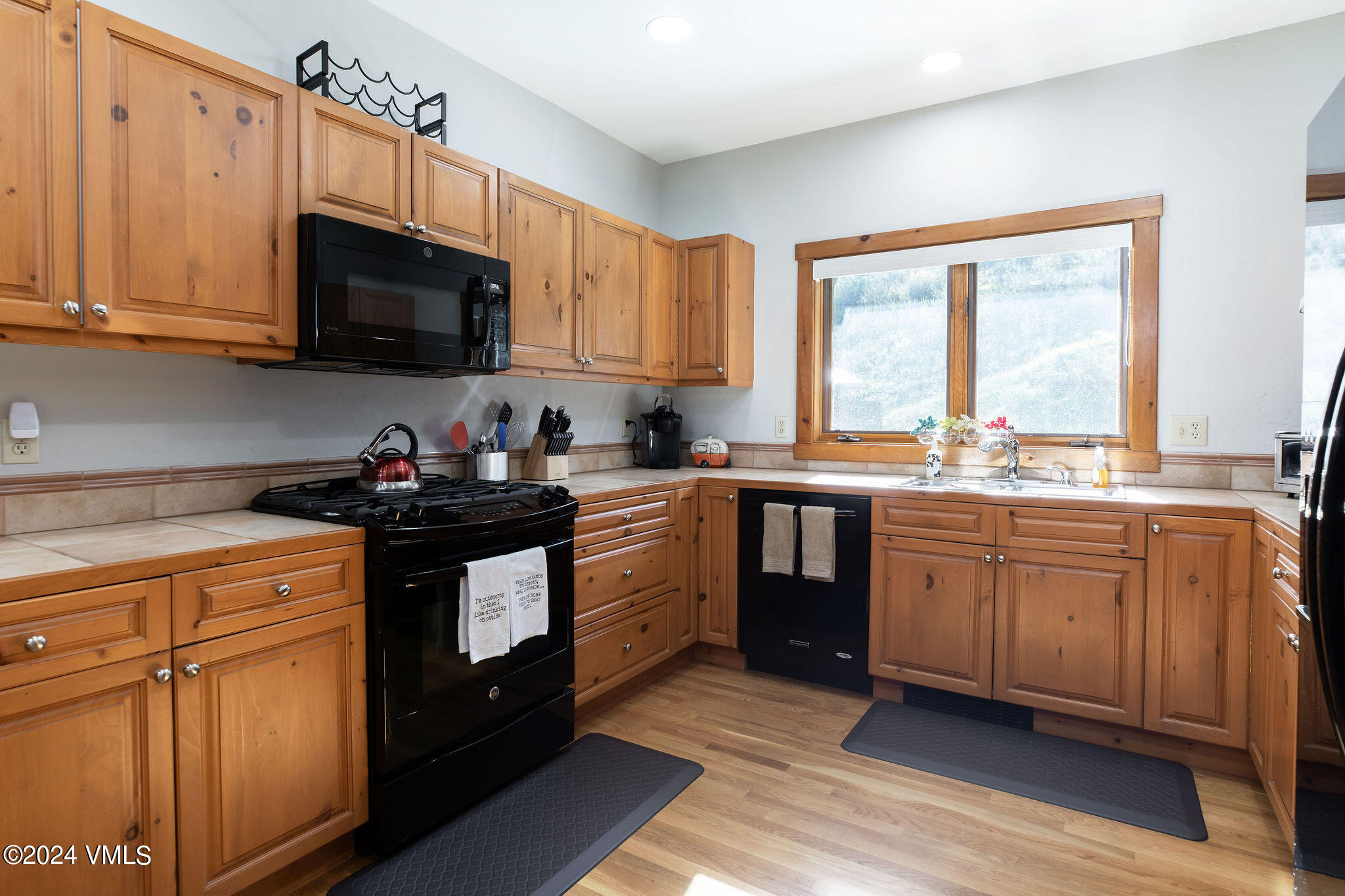 76 Knudson Ranch Road Edwards, CO 81632 - Photo 8 of 25 a kitchen with stainless steel appliances granite countertop a sink a stove a microwave and cabinets