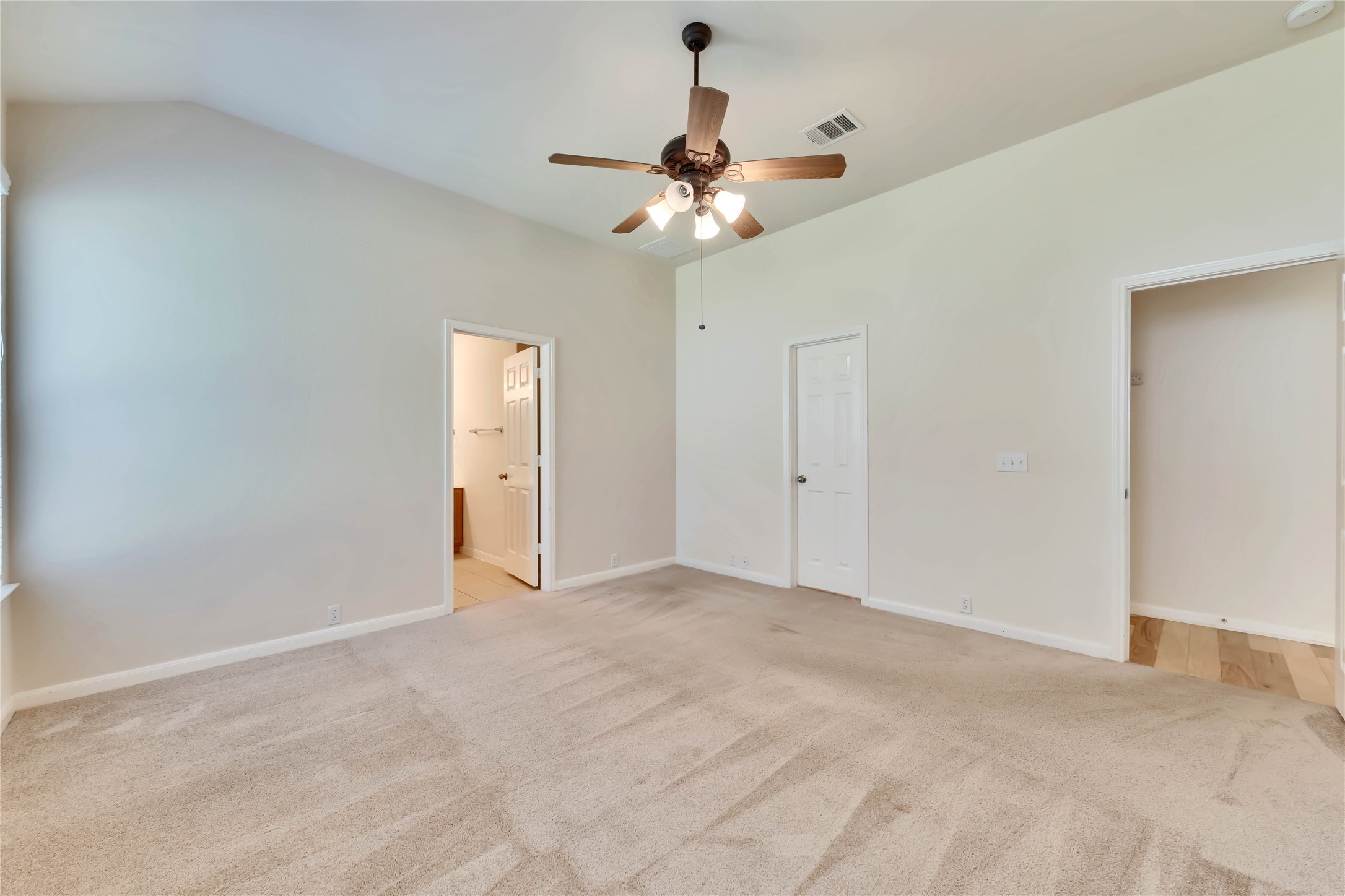 2133 Paradise Ridge Drive Round Rock, TX 78665 - Photo 17 of 22 Spacious room featuring vaulted ceilings, light-toned carpeting, and a ceiling fan with integrated lighting