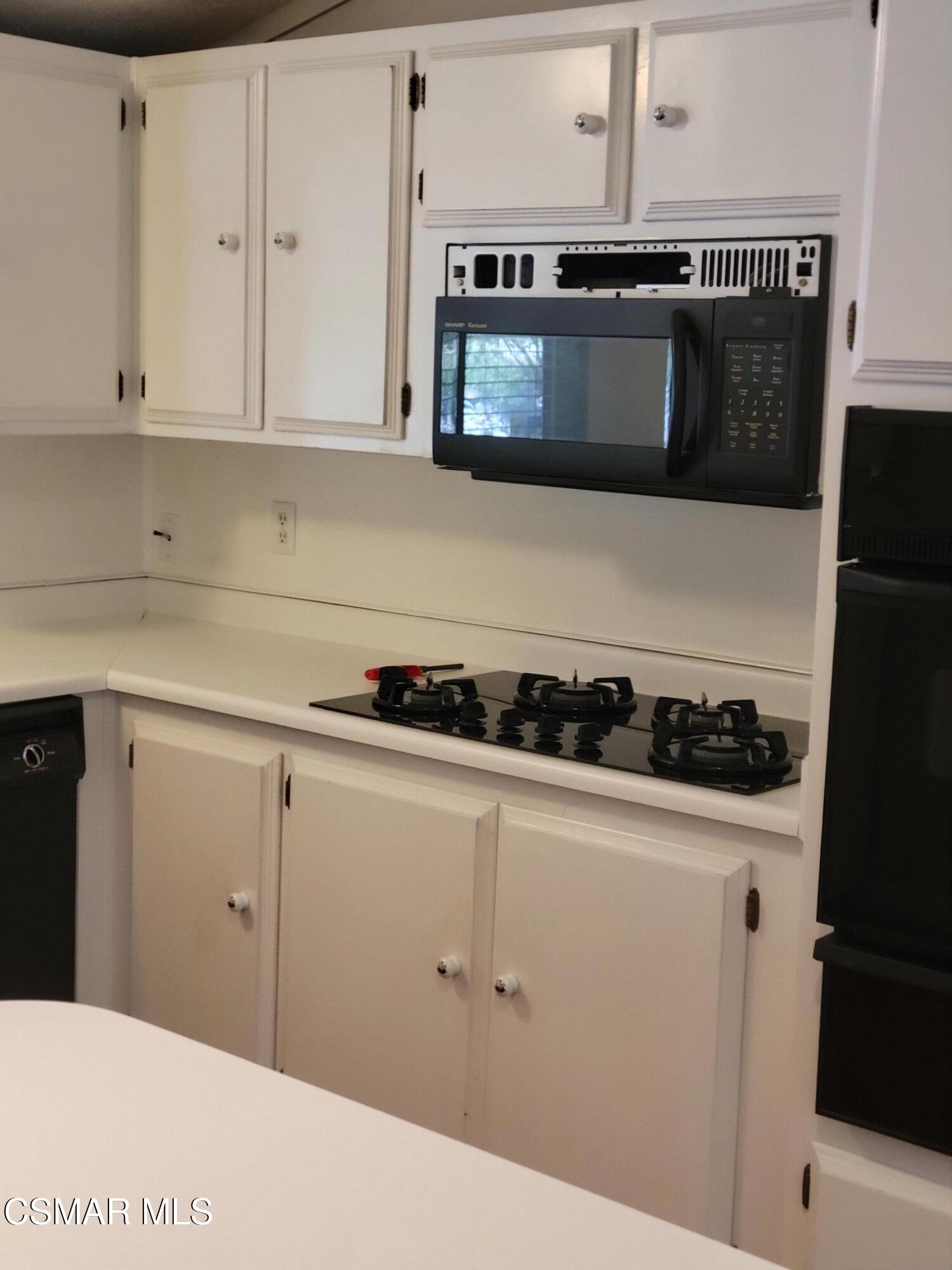 41 Old Castle Road Westlake Village, CA 91361 - Photo 5 of 13 a kitchen with a stove and a microwave