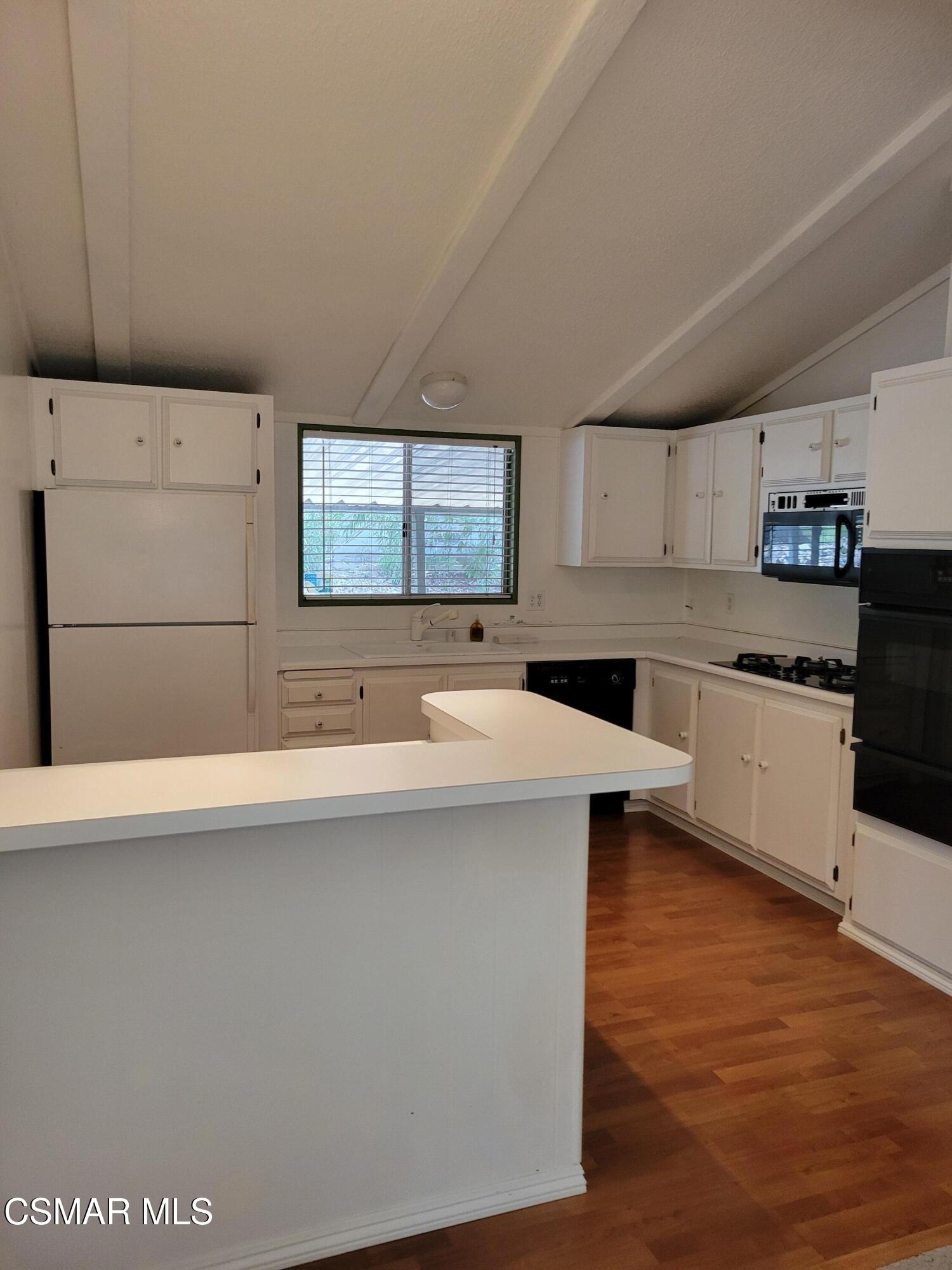 41 Old Castle Road Westlake Village, CA 91361 - Photo 6 of 13 a kitchen with stainless steel appliances a sink a stove a refrigerator counter top space and cabinets