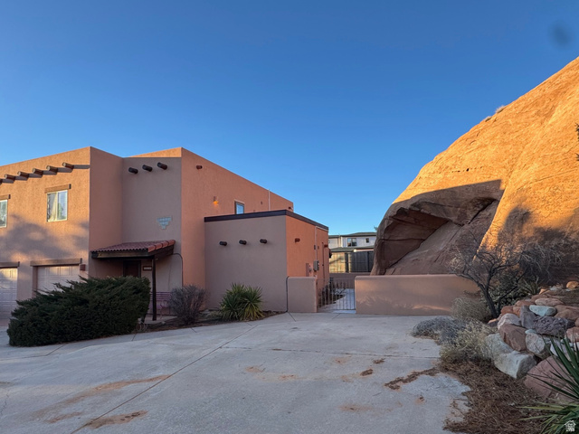 3439 Westwater Road Moab, UT 84532 - Photo 2 of 64 View of property exterior with a gate and stucco siding