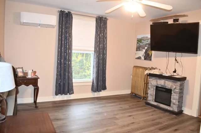 a living room with a fireplace and a flat screen tv