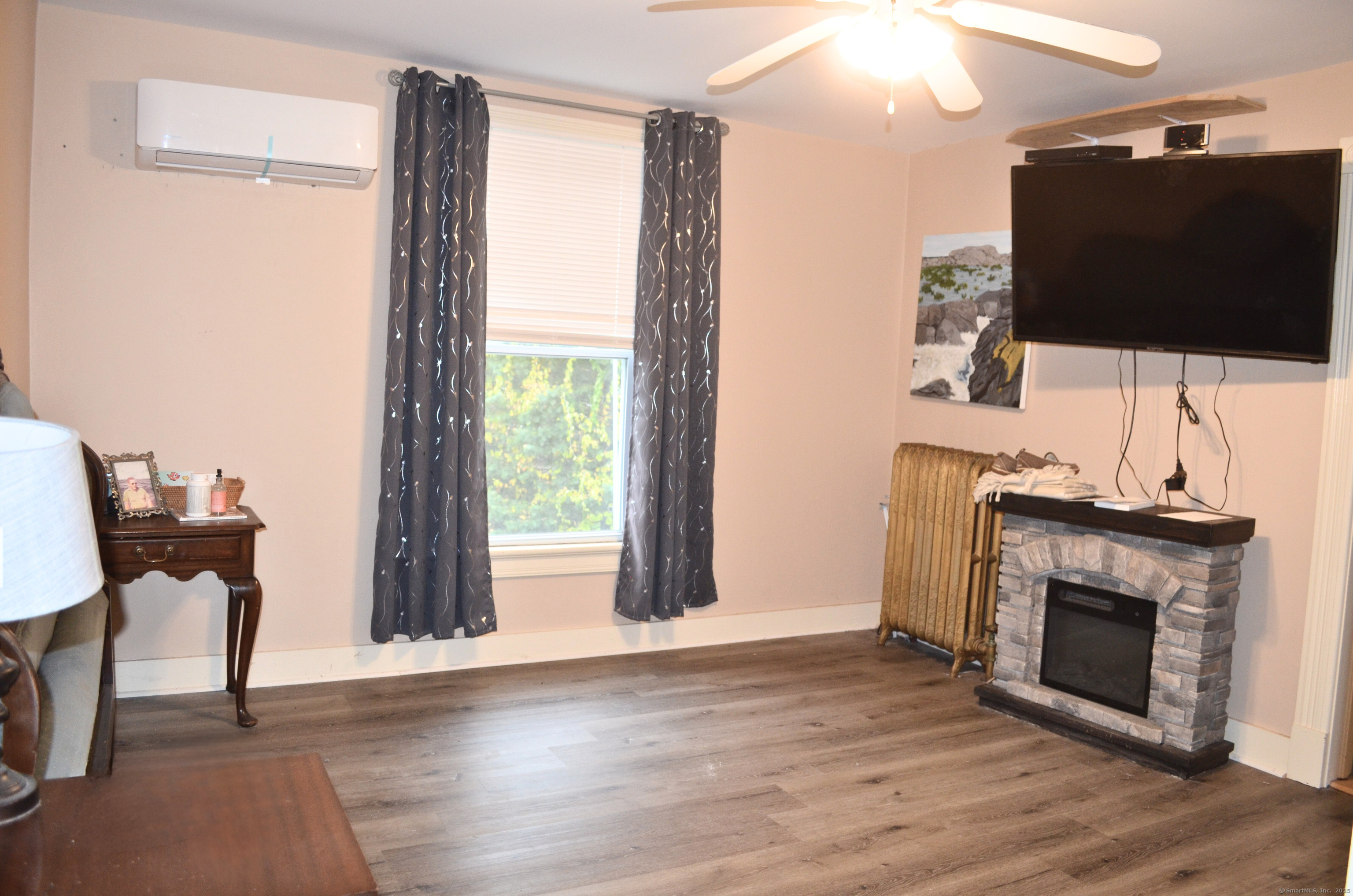 21 Shepard Road Norfolk, CT 06058 - Photo 14 of 17 a living room with a fireplace and a flat screen tv