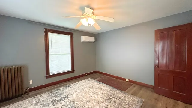 an empty room with windows and closet