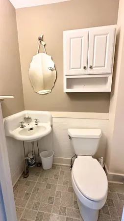 a bathroom with a sink a mirror and a toilet