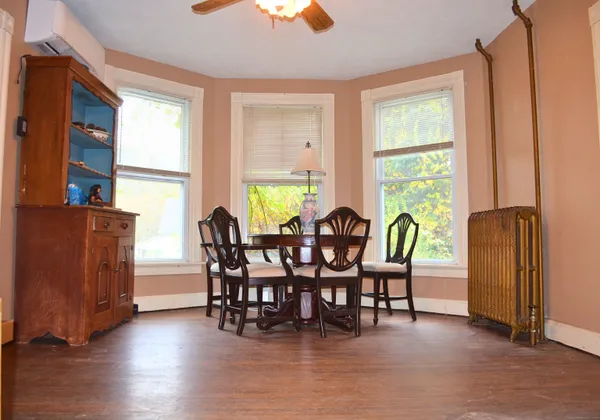 a view of a dining room with furniture and window