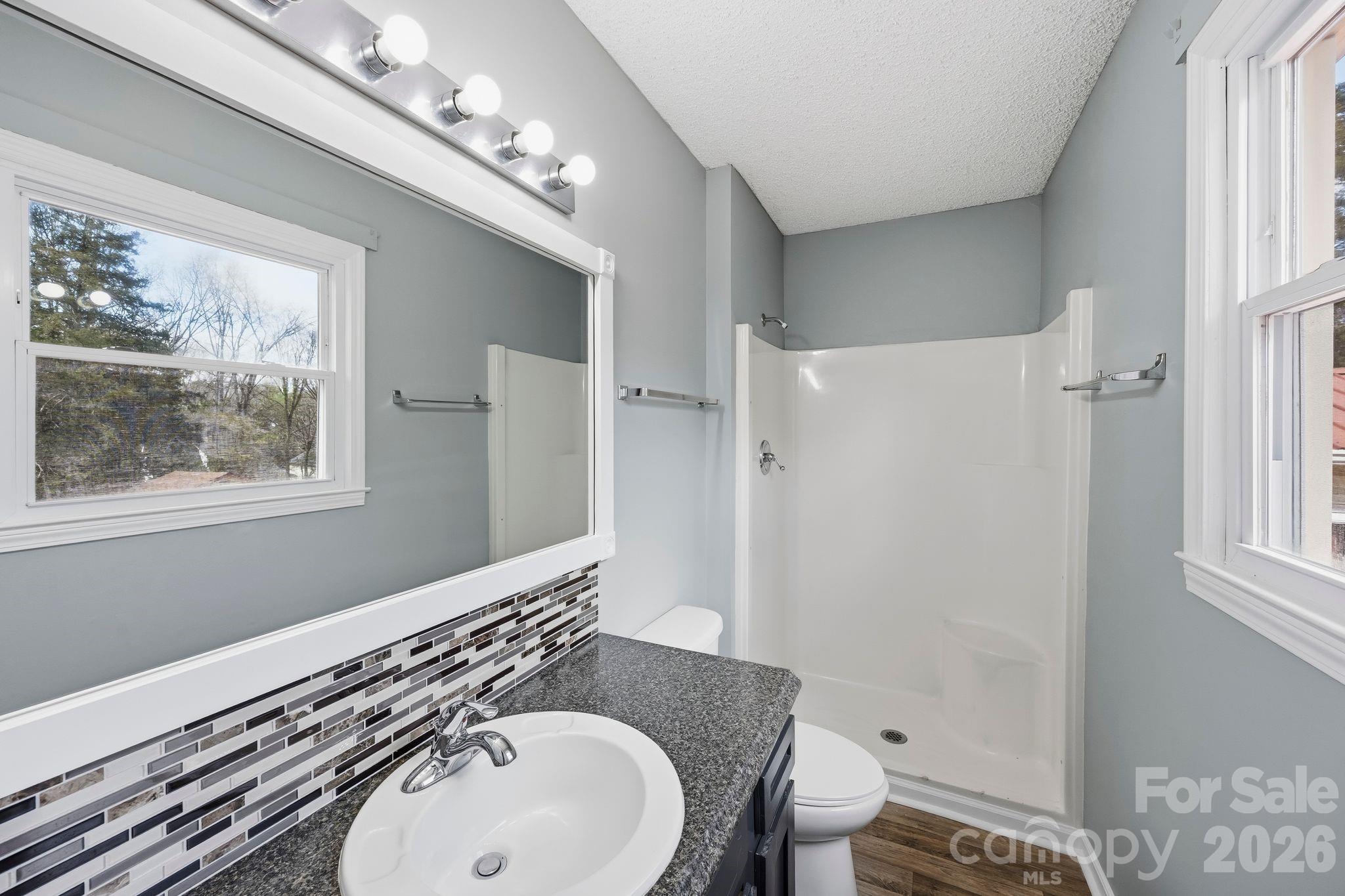 191 Fryling Avenue Southwest Concord, NC 28025 - Photo 18 of 25 a bathroom with a sink a toilet and a mirror