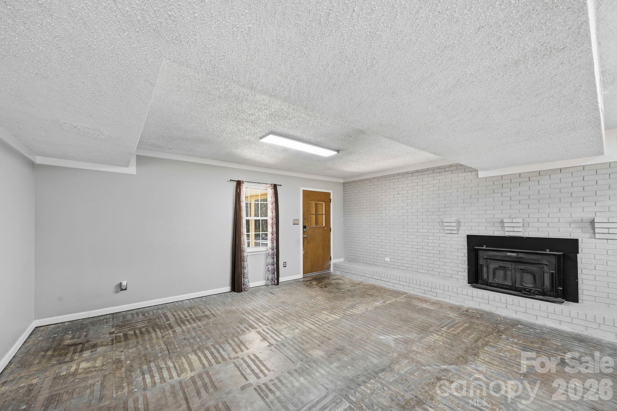 191 Fryling Avenue Southwest Concord, NC 28025 - Photo 20 of 25 an empty room with windows and fireplace