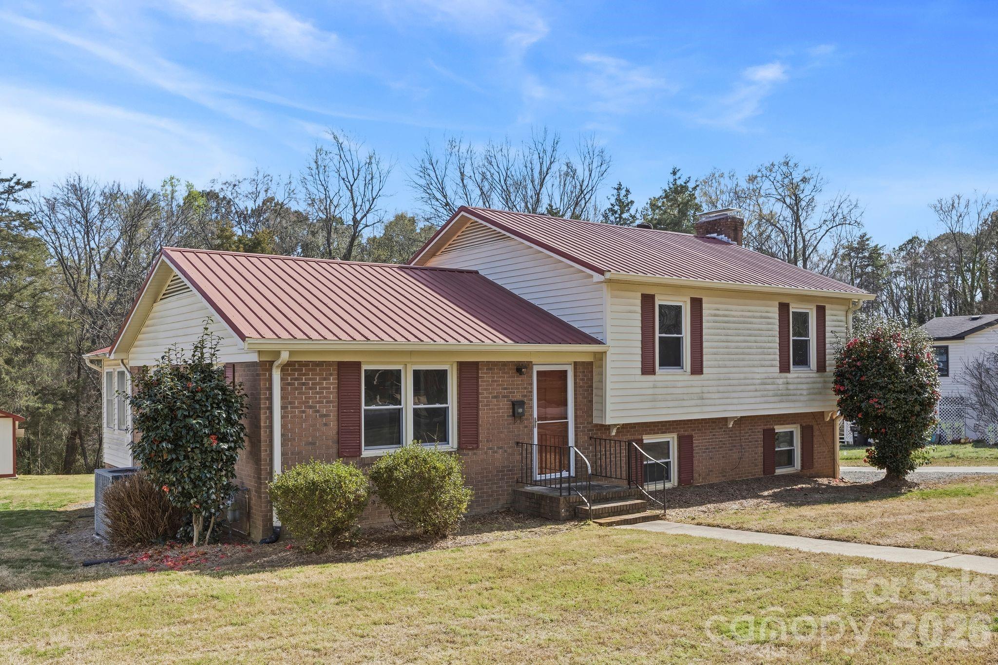 191 Fryling Avenue Southwest Concord, NC 28025 - Photo 4 of 25 a front view of a house with a garden and trees