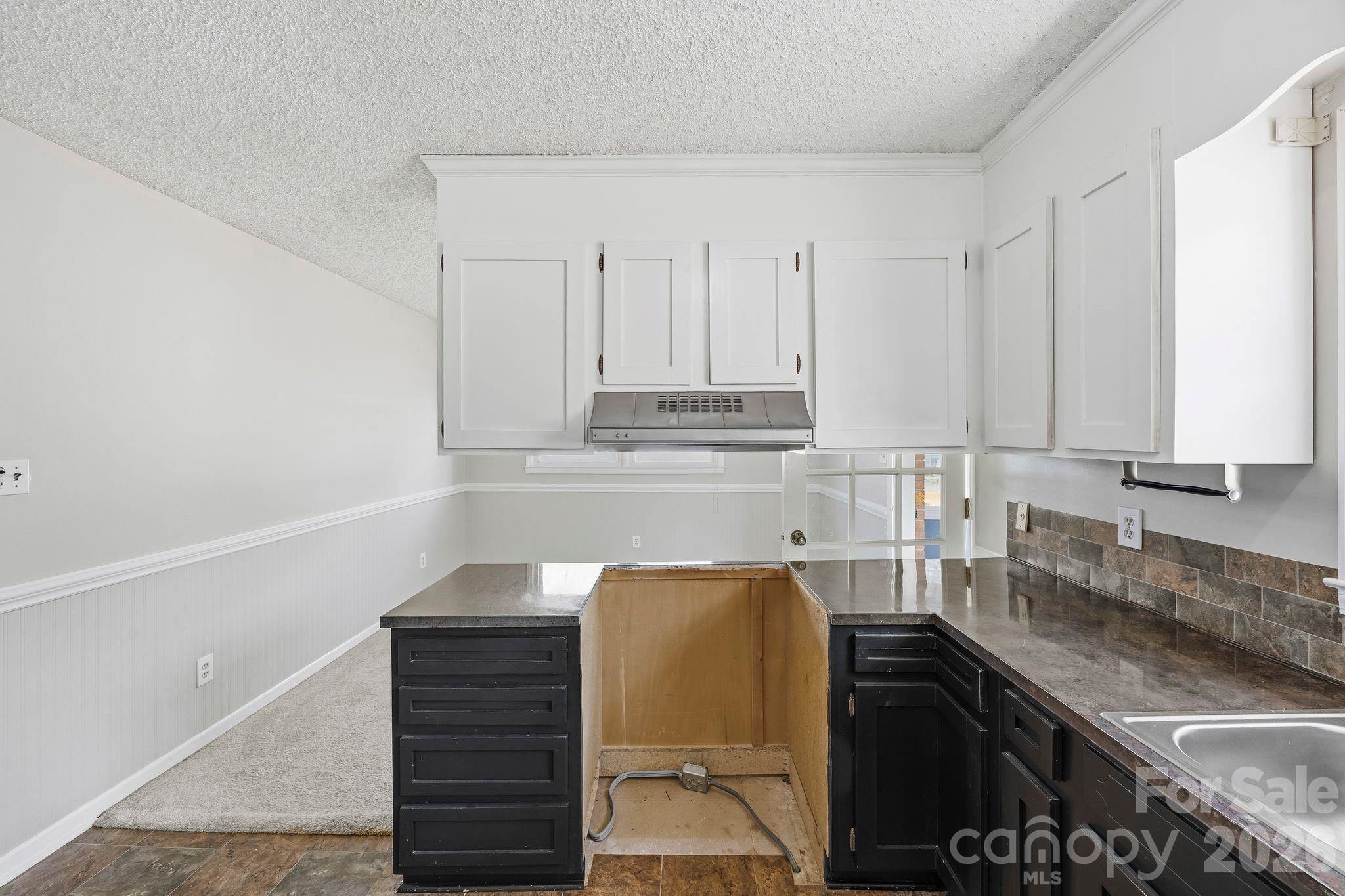 191 Fryling Avenue Southwest Concord, NC 28025 - Photo 10 of 25 a kitchen with a sink and cabinets