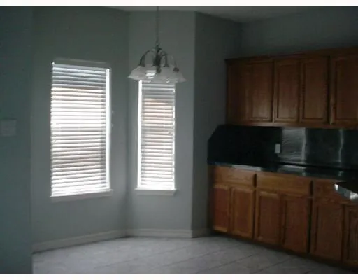 a kitchen with windows and cabinets