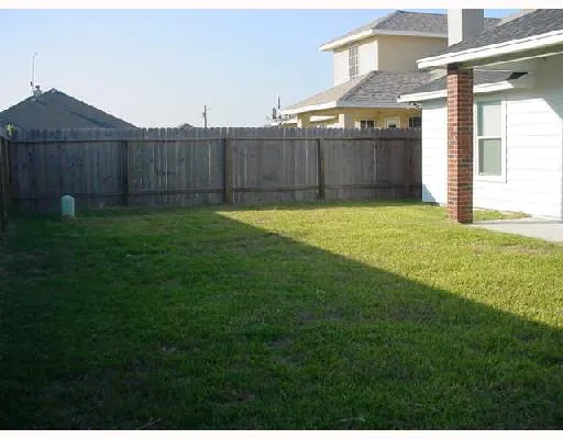 a view of a backyard with a garden and deck