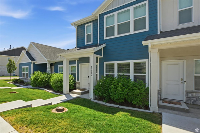 1213 West 1820th Street South Logan, UT 84321 - Photo 2 of 18 Modern townhome-style exterior featuring blue siding, white trim, and a covered entryway