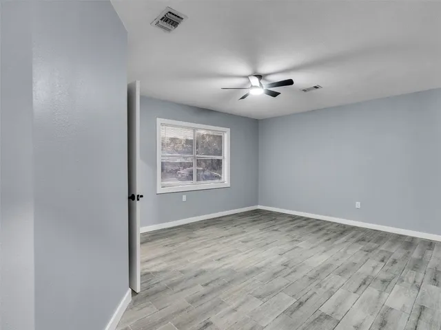 wooden floor in an empty room with a window