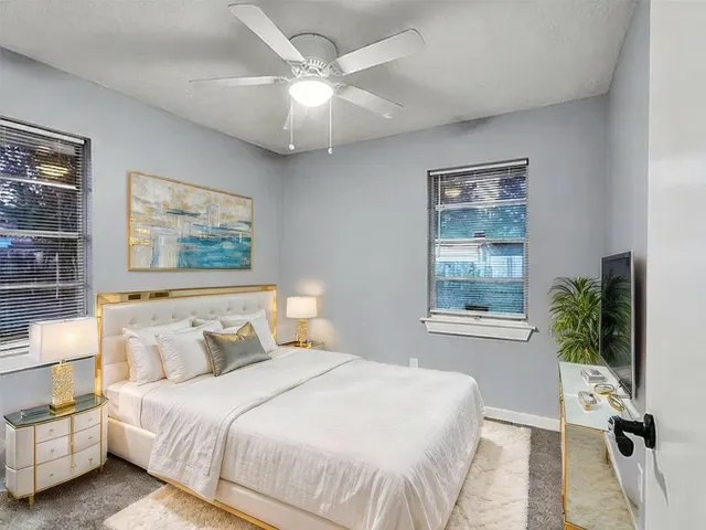 a bedroom with a large bed and a chandelier