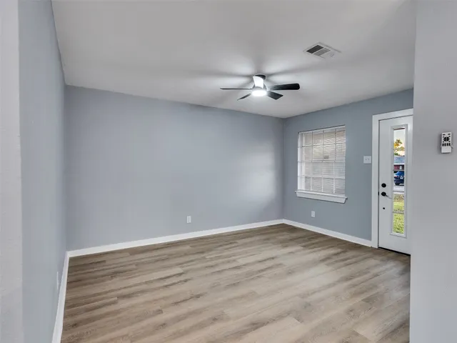 wooden floor in an empty room with a window
