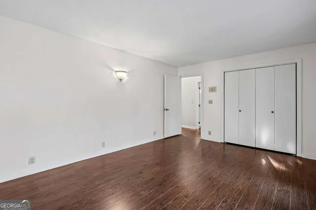 an empty room with wooden floor