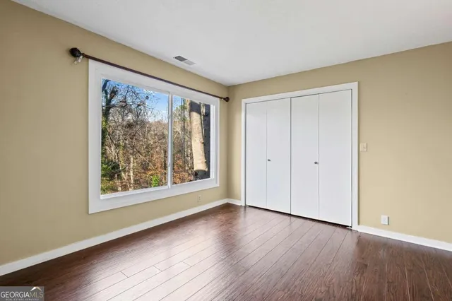 a view of a room with wooden floor and fan
