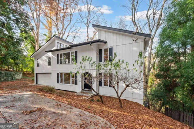 a view of a house with a yard and sitting area