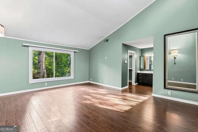 a view of a room with wooden floor