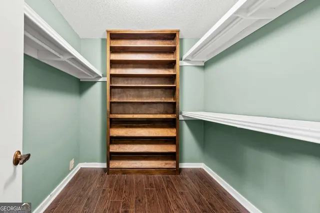 an empty room with wooden floor