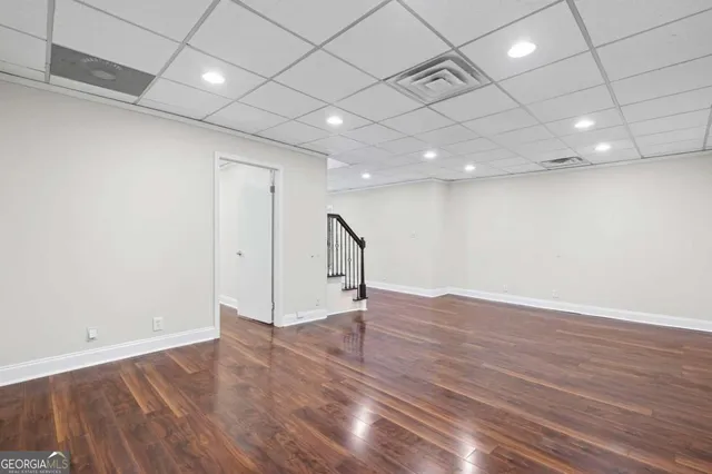 a view of a room with wooden floor