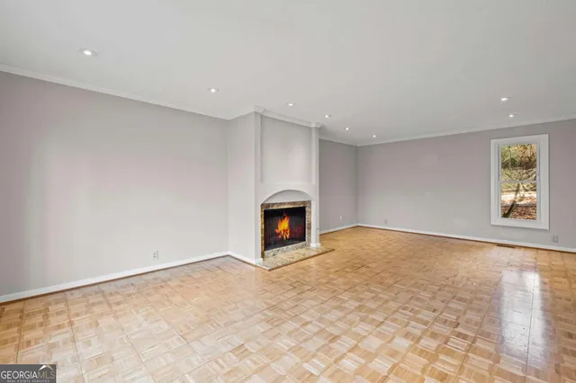 a view of an empty room with a fireplace and a window