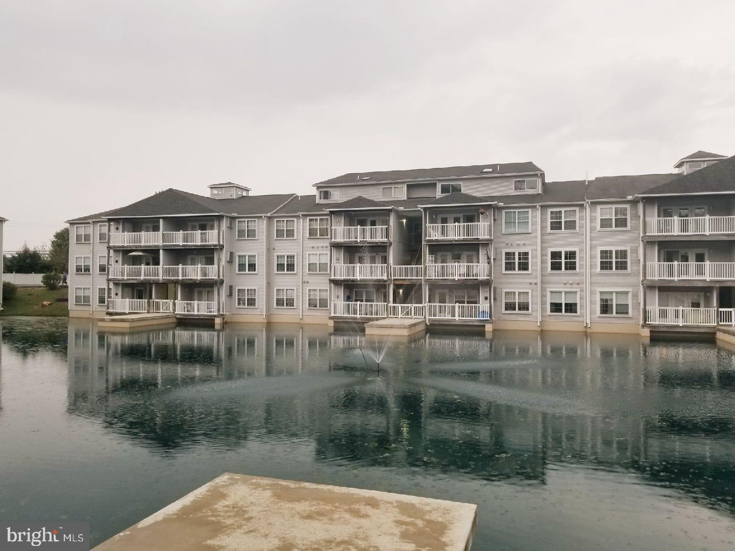 104 Waters Edge Drive, Unit 5 Newark, DE 19702 - Photo 1 of 1 a view of a lake with a building