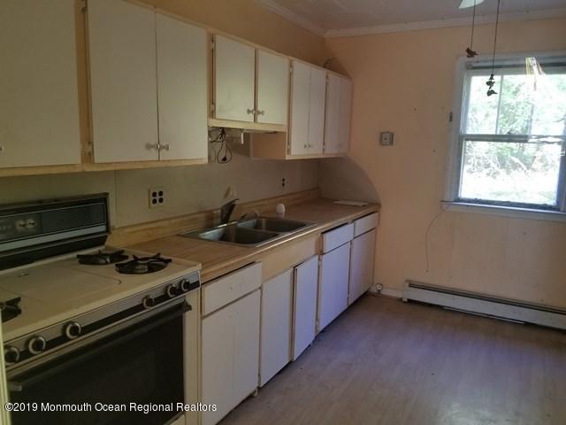608 Hulses Corner Road Howell, NJ 07731 - Photo 3 of 26 a kitchen with granite countertop a stove sink and cabinets