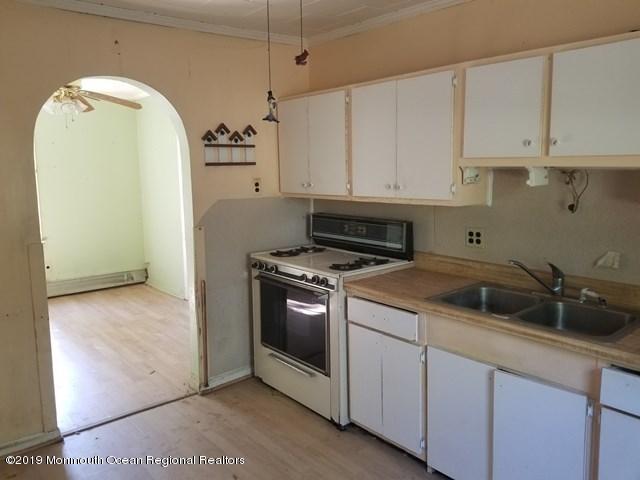 608 Hulses Corner Road Howell, NJ 07731 - Photo 4 of 26 a kitchen with white cabinets and white appliances