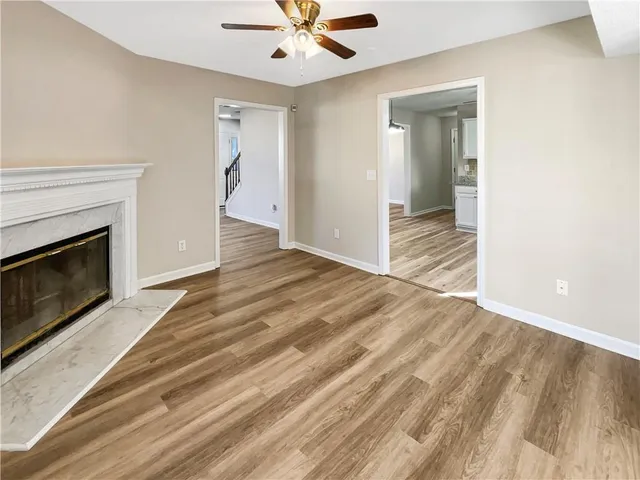 a view of an empty room and wooden floor