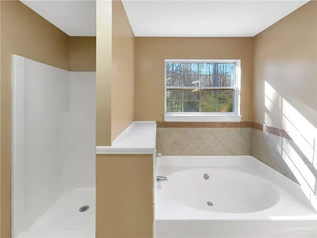 a bathroom with a bathtub and window