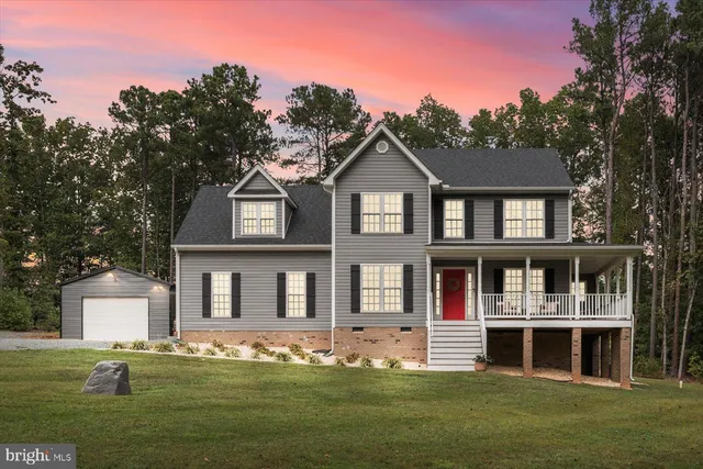 a front view of a house with a yard table and chairs