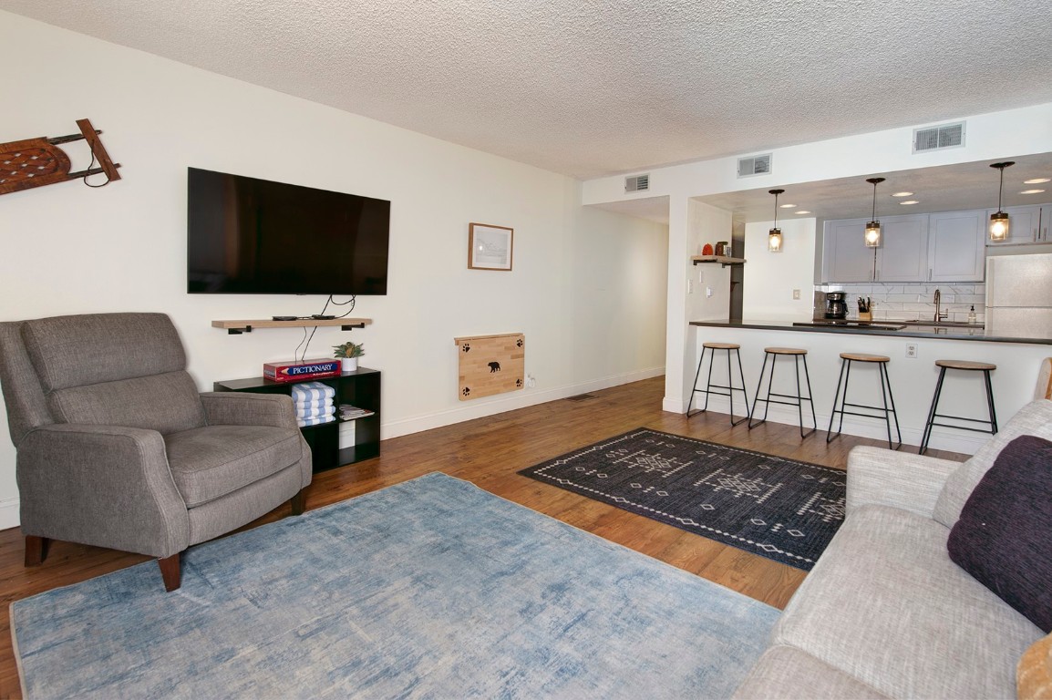 500 Bills Ranch Road, Unit 131 Frisco, CO 80443 - Photo 10 of 35 a living room with furniture and a flat screen tv