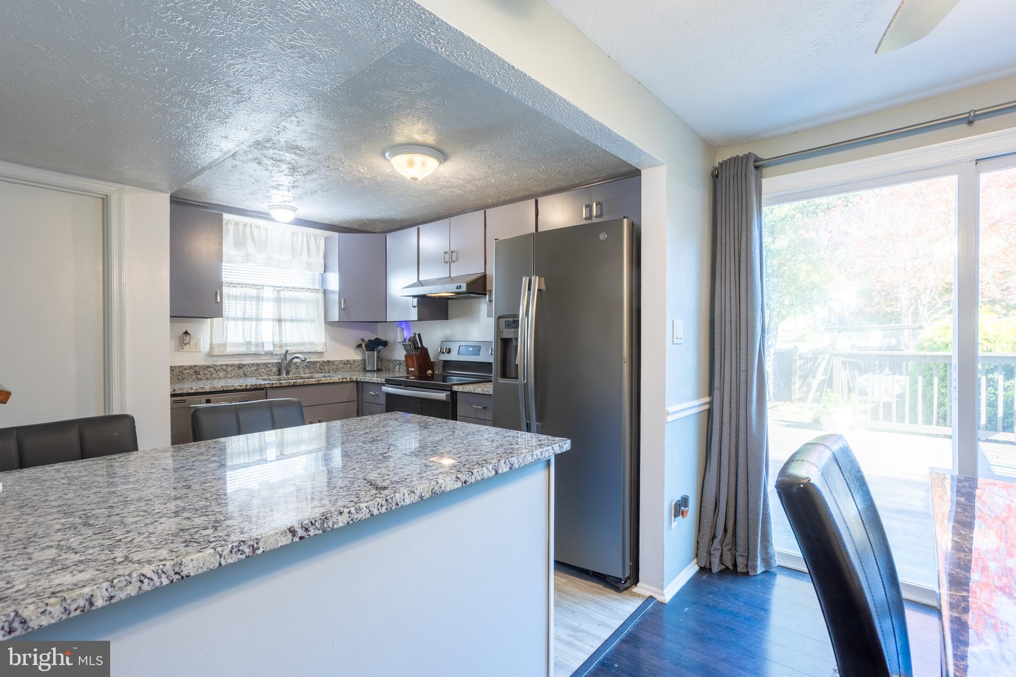 1583 Star Pine Drive Annapolis, MD 21409 - Photo 12 of 37 a kitchen with stainless steel appliances granite countertop a refrigerator a sink a stove a dining table and chairs
